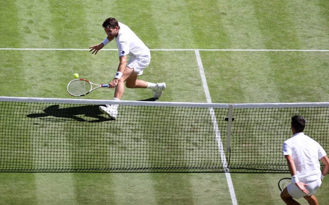 (220709) -- LONDON, July 9, 2022 -- Cameron Norrie (L) of Great Britain hits a return during the men s singles semifinal match against Novak Djokovic of Serbia at Wimbledon Tennis Championship in London, Britain, on July 8, 2022. ) (SP)BRITAIN-LONDON-TENNIS-WIMBLEDON-MEN S SINGLES-SEMIFINALS LixYing 
