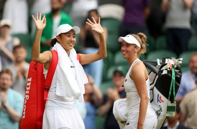 (220709) -- LONDON, July 9, 2022 -- Zhang Shuai of China waves to the spectators as Elise Mertens of Belgium looks on after they won the women s doubles semifinal match against Danielle Collins Desirae Krawczyk of the United States at Wimbledon Tennis Championship in London, Britain, on July 8, 2022. ) (SP)BRITAIN-LONDON-TENNIS-WIMBLEDON-WOMEN S DOUBLES-SEMIFINALS LixYing 