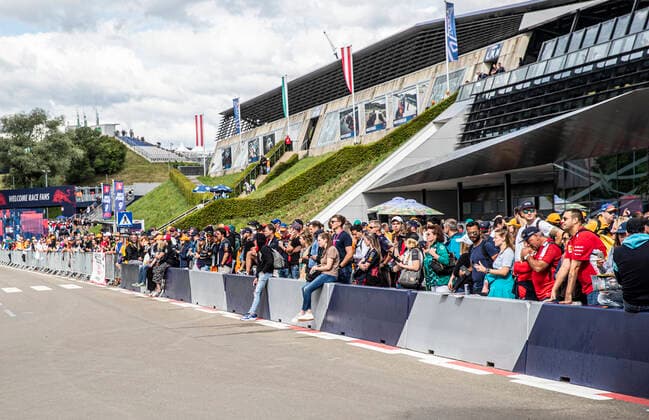 FORMULA 1 - GP of Austria 2022 SPIELBERG,AUSTRIA,09.JUL.22 - MOTORSPORTS, FORMULA 1 - Grand Prix of Austria, Red Bull Ring, fan area. Image shows fans waiting infront of the main building.  GEPAxpictures xWolfgangxJannach