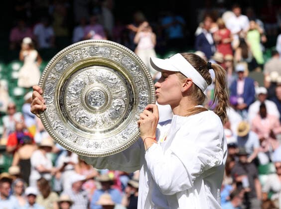 Kazakhstan s Elena Rybakina holds the trophy in victory in her Women s Final match against Tunisian Ons Jabeur at the 2022 Wimbledon championships in London on Saturday, July 9, 2022. Rybakina won the match 3-6,6-2,6-2.  LON2022070901 HUGOxPHILPOTT