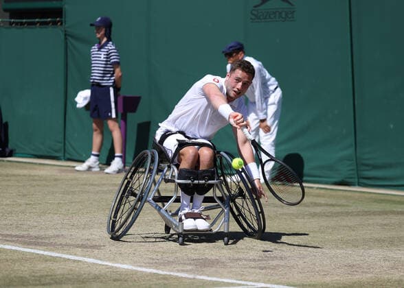10th July 2022, All England Lawn Tennis and Croquet Club, London, England; Wimbledon Tennis tournament; Alfie Hewett (GBR) plays a backhand to Shingo Kunieda (JPN) during the mens wheelchair final  ActionPlus12407109 JohnxPatrickxFletcher