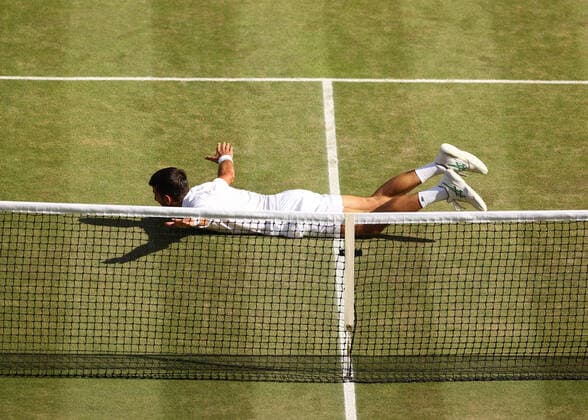 10th July 2022, All England Lawn Tennis and Croquet Club, London, England; Wimbledon Tennis tournament, mens singles final; Novak Djokovic (SRB) falls to the court and celebrates after defeating Nick Kyrgios (AUS)  ActionPlus12407303 JohnxPatrickxFletcher