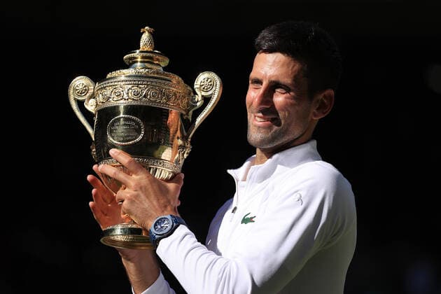 Tennis - Wimbledon (Day 14) 10th July 2022 - Tennis - Wimbledon (Day 14) - Novak Djokovic (SRB) poses with the trophy as he celebrates victory over Nick Kyrgios (AUS) in their Gentlemen s Singles Final - Photo: Simon Stacpoole Offside. London UK Copyright: xSimonxStacpoolexOffside