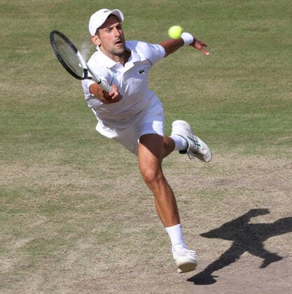 Serbian Novak Djokovic plays a forehand in the Men s Final match against Australian Nick Kyrgios on day fourteen of the 2022 Wimbledon championships in London on Sunday, July 10, 2022. Djokovic won the match 4-6,6-3,6-4,7-6.  LON2022071012 HUGOxPHILPOTT