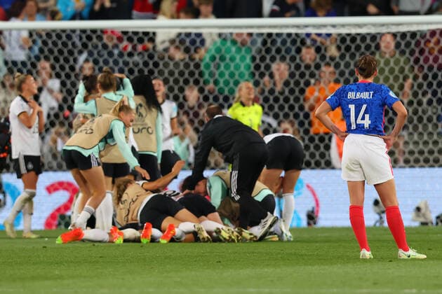 27th July 2022; Stadium MK, Milton Keynes, Bucks, England: Womens European International football tournament, semi-final; France versus Germany: A dejected Charlotte Bilbault of France observes the German team celebrating as they win 1-2 and progress to the final  ActionPlus12411201 ShaunxBrooks