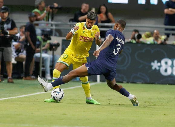 (220801) -- TEL AVIV, Aug. 1, 2022 -- Paris Saint-Germain player Presnel Kimpembe (R) tackles FC Nantes player Ludovic Blas during the French Champions Trophy (Trophee des Champions) football match at the Bloomfield Stadium in Tel Aviv, Israel, on July 31, 2022. (Alain Schieber via Xinhua) (SP)ISRAEL-TEL AVIV-TROPHEE DES CHAMPIONS JINI 