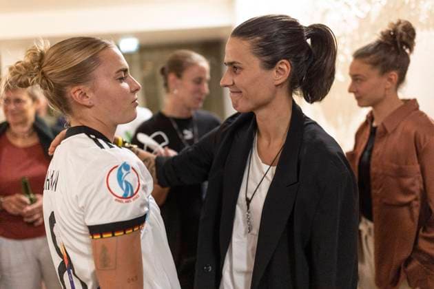 Banquet For The Germany Women s national team, Nationalteam LONDON, ENGLAND - JULY 31: Laura Freigang of Germany speaks with Dzsenifer Marozsan during a banquet for the Germany Women s National Team following the loss of the UEFA Women s EURO 2022 final match against England on July 31, 2022 in London, England. (Photo by Maja Hitij Getty Images for DFB) London England United Kingdom