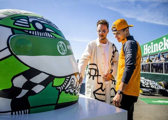 2022-08-31 12:05:05 ZANDVOORT - Lando Norris (McLaren) and artist Pablo Lucker on the Zandvoort circuit, in the run-up to the Dutch Grand Prix (GP). The GP took place last year in a modified form due to the corona measures. This year, up to 110,000 visitors a day are expected. ANP REMKO DE WAAL netherlands out - belgium out Zandvoort xVIxxIVx