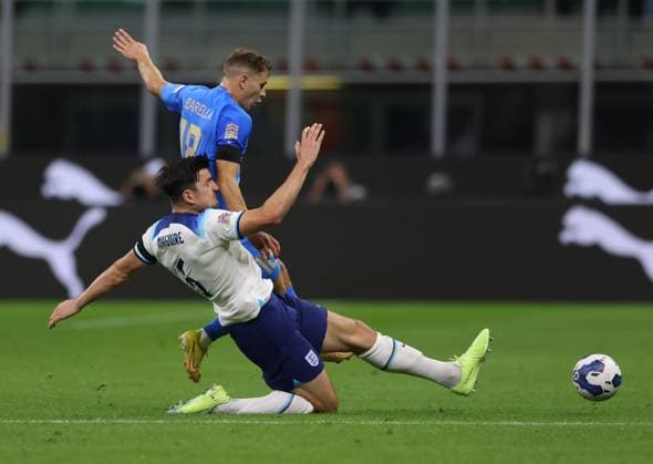 Milan, Italy, 23rd September 2022. Nicolo Barella of Italy tackled by Harry Maguire of England during the UEFA Nations League match at Stadio Giuseppe Meazza, Milan. Picture credit should read: Jonathan Moscrop Sportimage EDITORIAL USE ONLY. No use with unauthorised audio, video, data, fixture lists, club league logos or live services. Online in-match use limited to 120 images, no video emulation. No use in betting, games or single club league player publications. SPI-1892-0013