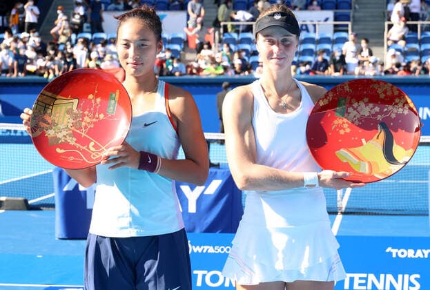 September 25, 2022, Tokyo, Japan - Liudmila Samsonova (R) of Russia holds the trophy as she won the singles of the Toray Pan Pacific Open tennis tournament while runner-up China s Zheng Qinwen (L) smiles at the Ariake Coliseum in Tokyo on Sunday, September 25, 2022. Samsonova defeated Zheng in the final 7-5, 7-5. Noxthirdxpartyxsales  (0169983708st)