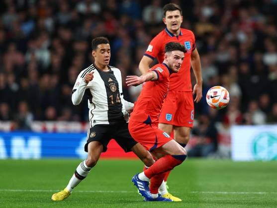London, England, 26th September 2022. Jamal Musiala of Germany tackled by Declan Rice of England during the UEFA Nations League match at Wembley Stadium, London. Picture credit should read: David Klein Sportimage EDITORIAL USE ONLY. No use with unauthorised audio, video, data, fixture lists, club league logos or live services. Online in-match use limited to 120 images, no video emulation. No use in betting, games or single club league player publications. SPI-1909-0029