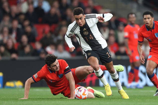 England v Germany 26 September 2022, London - UEFA Nations League - League A (Group 3) - England v Germany - Jamal Musiala of Germany avoids the tackle of Harry Maguire of England - Photo: Charlotte Wilson Offside. London UK Copyright: xCharlottexWilsonx xOffsidexOffside