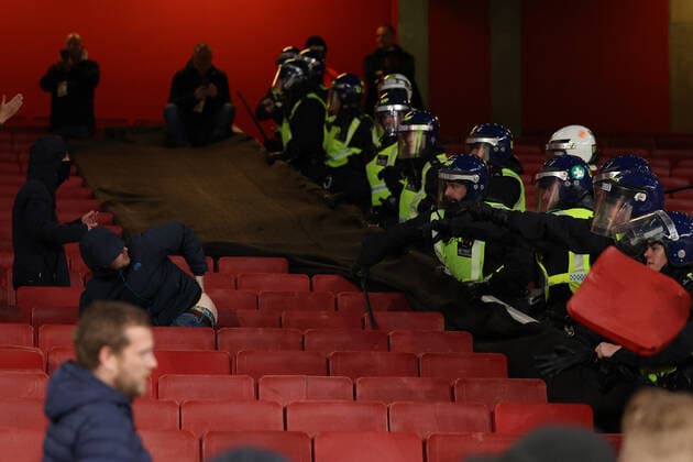 20th October 2022; Emirates Stadium, London, England; Europa League Football, Arsenal versus PSV Eindhoven; A PSV Eindhoven fans moons the Police riot squad  ActionPlus12438094 ShaunxBrooks