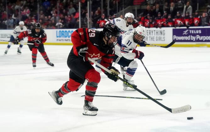 November 15, 2022, Kelowna, BC, Canada: Canada s Marie-Philip Poulin (29) skates past United States Abby Roque (11) during overtime Rivalry Series hockey action in Kelowna, B.C., Tuesday, Nov. 15, 2022. Canada News - November 15, 2022  - ZUMAc35_ 20221115_zaf_c35_207 Copyright: xJessexJohnstonx