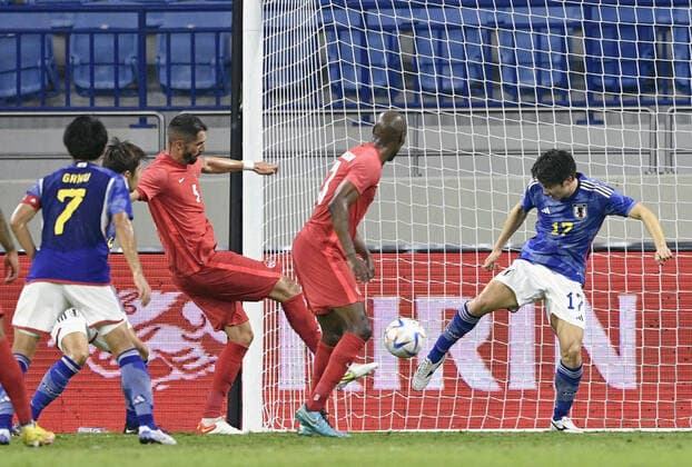 Football: Japan-Canada pre-World Cup friendly Canada s Steven Vitoria (L in red) scores an equalizer in the first half of a friendly football match against Japan in Dubai on Nov. 17, 2022, ahead of the World Cup in Qatar. Canada won 2-1.  A14AA0001356517P 