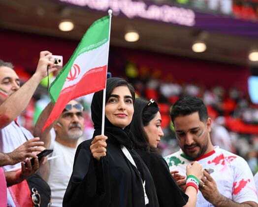 FUSSBALL WM 2022 VORRUNDE GRUPPE B Wales - Iran 25.11.2022 Eine Frau mit Schleier und iranischen Faehnchen *** FOOTBALL WORLD CUP 2022 PRE-ROUND GROUP B Wales Iran 25 11 2022 A woman with veil and Iranian faehnchen