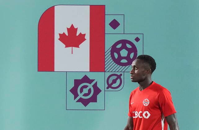 November 25, 2022, DOHA, QATAR: Canada midfielder Richie Laryea walks next to his countries national flag during practice at the World Cup in Doha, Qatar, Friday, Nov. 25, 2022. Canada News - November 25, 2022  - ZUMAc35_ 20221125_zaf_c35_043 Copyright: xNathanxDenettex
