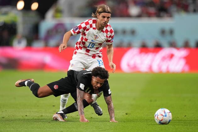 November 27, 2022, AL RAYYAN, QATAR: Canada forward Tajon Buchanan (11) goes to ground as Croatia defender Borna Sosa (19) challenges for the ball during first half group F World Cup soccer action at the Khalifa International Stadium in Al Rayyan, Qatar on Sunday, November 27, 2022. Canada News - November 27, 2022  - ZUMAc35_ 20221127_zaf_c35_029 Copyright: xNathanxDenettex
