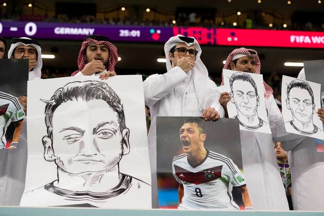 AL KHOR, QATAR - NOVEMBER 27: People in the stands hold portraits of German football player Mesut Ã–zil in a protest against Uyghur discrimination in China during the FIFA World Cup, WM, Weltmeisterschaft, Fussball Qatar 2022 Group E match between Spain and Germany at Al Bayt Stadium on November 27, 2022 in Al Khor, Qatar. (Photo by Sebastian Frej) WCS  Copyright: xSebastianxFrej