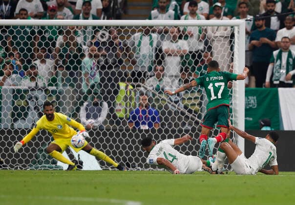 Saudi Arabia v Mexico 2022 FIFA World Cup, WM, Weltmeisterschaft, Fussball Orbelin Pineda of Mexico has a shot at goal as he jumps over the tackle from Abdulelah Al-Amri and Ali Al-Hassan of Saudi Arabia during the 2022 FIFA World Cup Group C match at Lusail Stadium, Lusail Content Not Available For UK Newspapers Copyright: xPaulxChestertonx FIL-17655-0087 UK Newspapers OUT