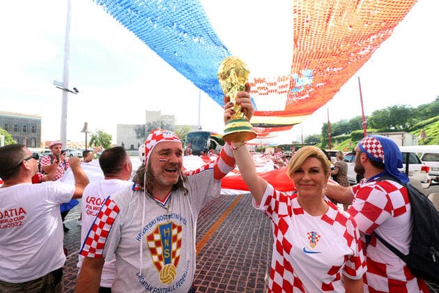 Former President of Croatia with Croatian fans - FIFA World Cup, WM, Weltmeisterschaft, Fussball Qatar 2022 Former President of Croatia Kolinda Grabar-Kitarovic pose with Croatian supporter with FIFA World Cup Trophy under a 200 meters long flag ahead of the match against Belgium in Doha, Qatar, on December 01, 2022. GoranxStanzl PIXSELL
