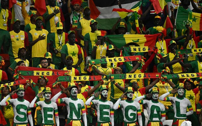 (221204) -- AL KHOR, Dec. 4, 2022 -- Fans of Senegal cheer prior to the Round of 16 match between England and Senegal of the 2022 FIFA World Cup, WM, Weltmeisterschaft, Fussball at Al Bayt Stadium in Al Khor, Qatar, Dec. 4, 2022. ) (SP)QATAR-AL KHOR-2022 WORLD CUP-ROUND OF 16-ENG VS SEN LixGa 