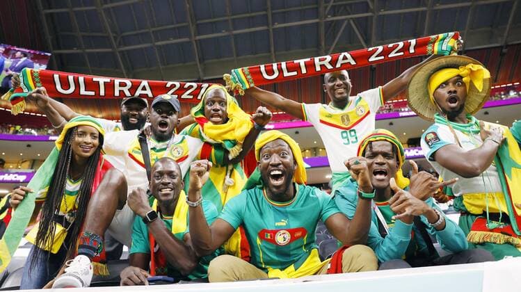 Football World Cup in Qatar Fans wearing Senegal s national colors of red, gold and green pose for a photo before a World Cup round of 16 football match against England at Al Bayt Stadium in Al Khor, Qatar, on Dec. 4, 2022.  A14AA0001370547P 