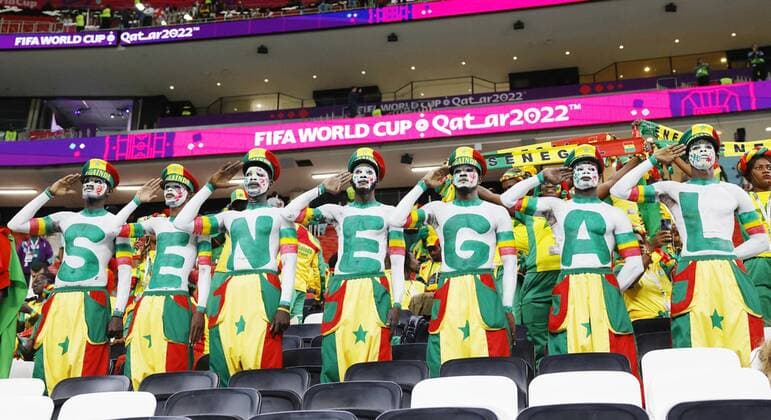 Football World Cup in Qatar Senegal fans with painted letters across their midriffs perform a hand salute in the stands before a World Cup round of 16 football match against England at Al Bayt Stadium in Al Khor, Qatar, on Dec. 4, 2022.  A14AA0001370554P 