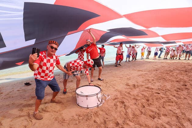 QATAR 2022 - Croatian fans unfurled a 200m long flag on the beach in front of the Hilton Doha Hotel Croatian fans unfurled a 200m long flag on the beach in front of the Hilton Doha Hotel to support the national team, Nationalteam before the semi-final match against Argentina at the World Cup in Qatar, in Doha, Qatar, on December 13, 2022, IgorxKralj PIXSELL