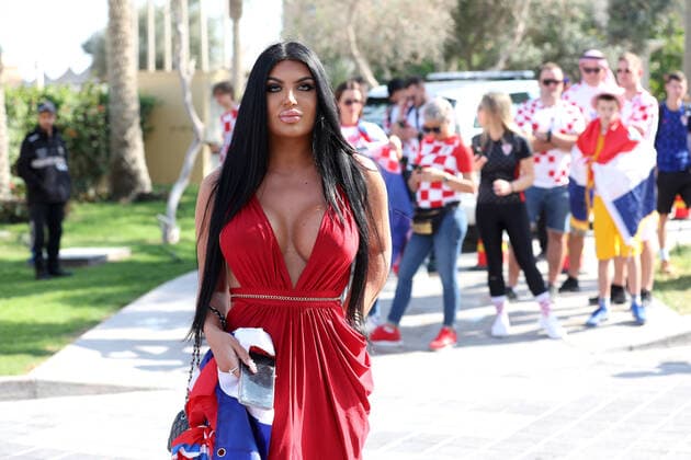 QATAR 2022 - Magdalena with the Croatian fans Magdalena from Mannheim is waiting for the semi-final match in the company of Croatian fans. Croatian fans unfurled a 200m long flag on the beach in front of the Hilton Doha Hotel to support the national team, Nationalteam before the semi-final match against Argentina at the World Cup in Qatar, in Doha, Qatar, on December 13, 2022, IgorxKralj PIXSELL
