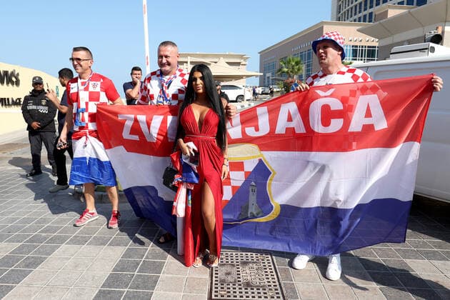 QATAR 2022 - Magdalena with the Croatian fans Magdalena from Mannheim is waiting for the semi-final match in the company of Croatian fans. Croatian fans unfurled a 200m long flag on the beach in front of the Hilton Doha Hotel to support the national team, Nationalteam before the semi-final match against Argentina at the World Cup in Qatar, in Doha, Qatar, on December 13, 2022, IgorxKralj PIXSELL
