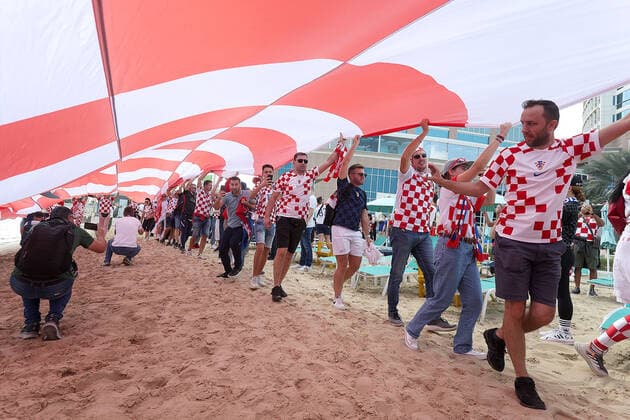 Croatia fans carry 200 meters flag Supporters of Croatia are seen prior FIFA World Cup, WM, Weltmeisterschaft, Fussball Qatar 2022 bronze medal match between Croatia and Morocco at Hilton Doha beach in Doha, Qatar on December 17, 2022. Fans carry 200 meters long flag of Croatia. GoranxStanzl PIXSELL
