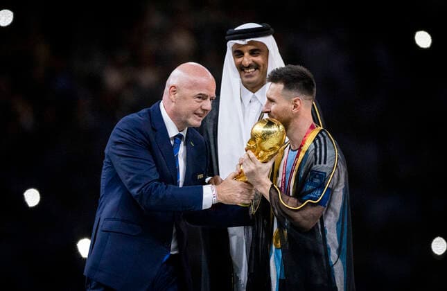 Doha, Qatar. 18th Dec, 2022. Lionel Messi of Argentina carries the FIFA World Cup, WM, Weltmeisterschaft, Fussball Qatar 2022 Winner s Trophy as Gianni Infantino, President of FIFA, and Sheikh Tamim bin Hamad Al Thani, Emir of Qatar, look on during the FIFA World Cup Qatar 2022 Final match between Argentina - France Final Match Argentinien - Frankreich World Cup 2022 in Qatar 18.12.2022