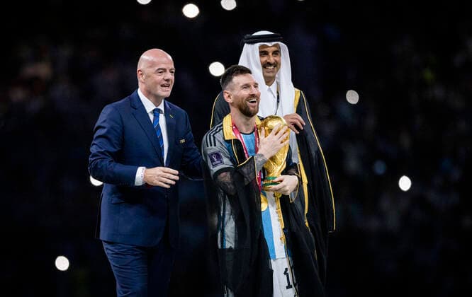 Doha, Qatar. 18th Dec, 2022. Lionel Messi of Argentina carries the FIFA World Cup, WM, Weltmeisterschaft, Fussball Qatar 2022 Winner s Trophy as Gianni Infantino, President of FIFA, and Sheikh Tamim bin Hamad Al Thani, Emir of Qatar, look on during the FIFA World Cup Qatar 2022 Final match between Argentina - France Final Match Argentinien - Frankreich World Cup 2022 in Qatar 18.12.2022