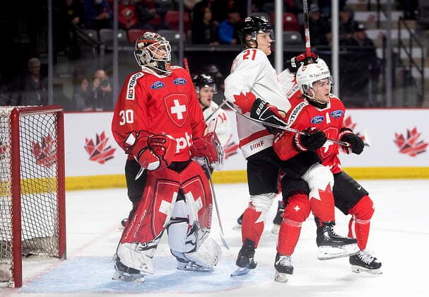 December 19, 2022, Moncton, NB, Canada: Switzerland goaltender Kevin Pasche looks for the puck as Canada™s Nathan Gaucher and Switzerland™s Dario Sidler battle in front during second period IIHF World Junior Hockey Championship pre-tournament hockey action in Moncton, N.B., on Monday, Dec. 19, 2022. Canada News - December 19, 2022  - ZUMAc35_ 20221219_zaf_c35_065 Copyright: xRonxWardx