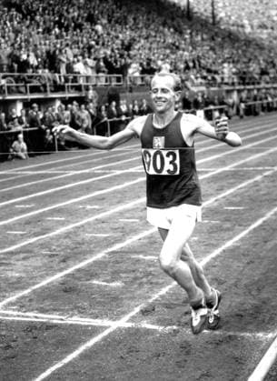 Emil Zatopek Emil Zatopek of Czechoslovakia smiles with joy as he wins the Olympic marathon in 2 hours 23 minutes and 3.2 seconds. 27th July 1952. Finland  Copyright: xTopFotox 0091427