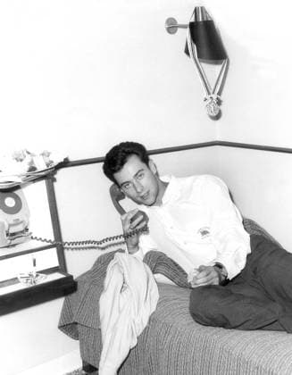 Lynn Davies With his gold medal hanging on a lampshade above his head Lynn Davies of Wales relaxes after arriving back from the Olympics in Tokyo, Japan. 29th October 1964 Great Britain  Copyright: xTopFotox 0155456