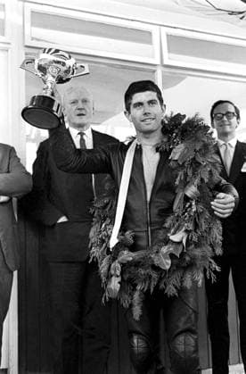 Giacomo Agostini Brands Hatch Kent, wearing the victory garland and waving aloft his trophy Giacomo Agostini the brilliant young Italian Motorcyclist is pictured after winning the International race of the South at Brands Hatch 9th October 1966 Great Britain  Copyright: xTopFotox 0199807