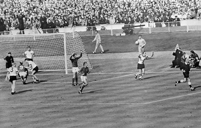 Controversial third goal. Wembley, England : Swiss referee, Gottfried Dienst (right ) runs out to consult the Russian linesman as England s Bobby Charlton ( no. 9 ) tries to demonstrate to the German players that Geoff Hurst s shot was a goal. Hurst ( arms raised ) watches anxiously while team mate , Roger Hunt , runs after the referee . The ball hit the crossbar and rebounded down . All the England players claimed the ball had crossed the line to register England s third goal . After consulting the linesman the referee allowed the goal . 30 July 1966 United Kingdom England  Copyright: xTopFotox 1391569