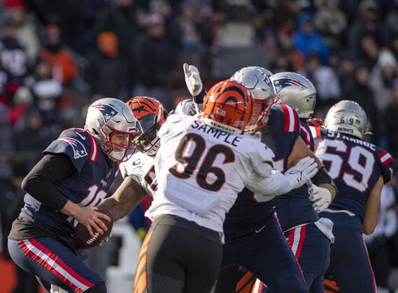 New England Patriots quarterback Mac Jones (10) braces for impact during the first half of a game against the Cincinnati Bengals at Gillette Stadium in Foxborough, Massachusetts on Saturday, December 24, 2022.  BOS20221224102