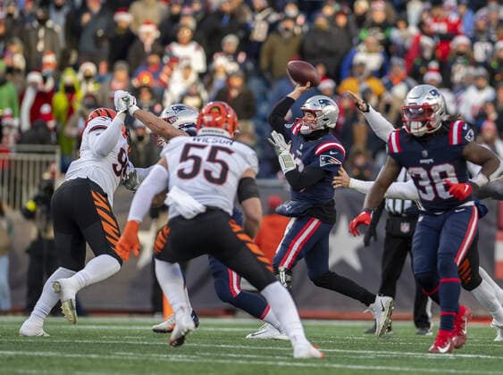 New England Patriots quarterback Mac Jones (10) looks for a pass during the second half of a game at Gillette Stadium against the Cincinnati Bengals in Foxborough, Massachusetts on Saturday, December 24, 2022.  BOS20221224118