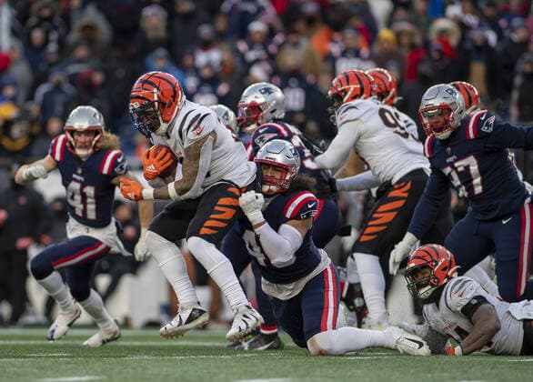 Cincinnati Bengals running back Trayveon Williams (32) drags New England Patriots linebacker Jahlani Tavai (48) as he tries to gain yardage during the second half of a game at Gillette Stadium in Foxborough, Massachusetts on Saturday, December 24, 2022.  BOS20221224122