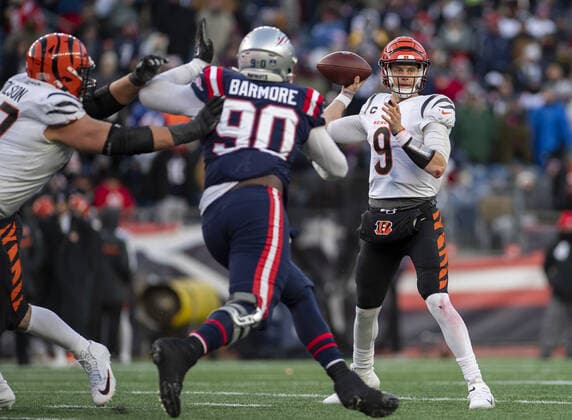 Cincinnati Bengals quarterback Joe Burrow (9) looks for a pass during the second half of a game against the New England Patriots at Gillette Stadium in Foxborough, Massachusetts on Saturday, December 24, 2022.  BOS20221224124