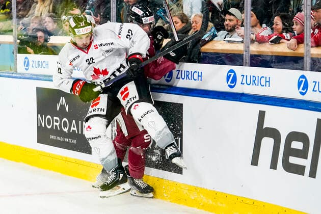 DAVOS, SWITZERLAND - DECEMBER 26: Alan Quine of Team Canada hit on Ondrej Miklis of Sparta Prague during the match between HC Sparta Praha and Team Canada at Hockey Club Davos on December 26, 2022 in Davos, Switzerland. Davos Graubunden Switzerland Copyright: xJustPictures.ch JarixPestelaccix