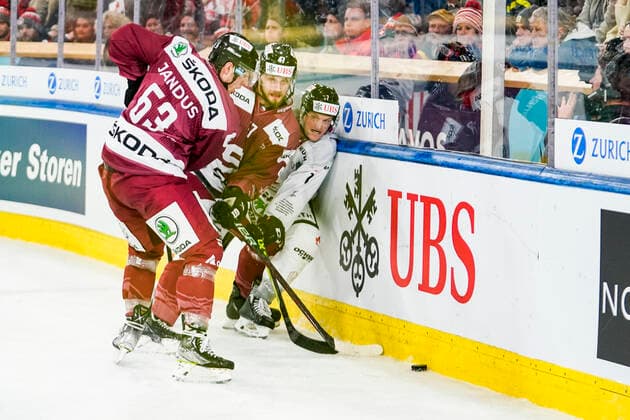 DAVOS, SWITZERLAND - DECEMBER 26: Daniel Carr of Team Canada against Martin Jandus of Sparta Prague (L) and Jan Buchtele of Sparta Prague (C) during the match between HC Sparta Praha and Team Canada at Hockey Club Davos on December 26, 2022 in Davos, Switzerland. Davos Graubunden Switzerland Copyright: xJustPictures.ch JarixPestelaccix