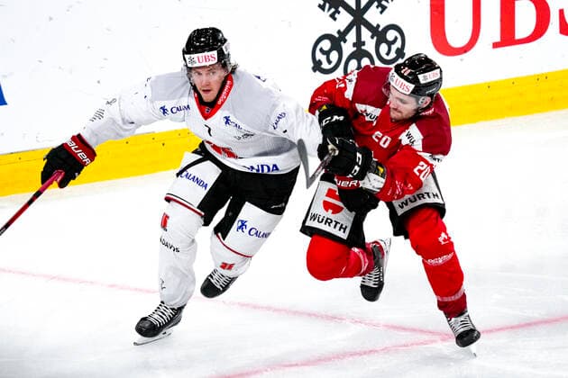 DAVOS, SWITZERLAND - DECEMBER 29: Marcus Hardegrd of Örebro HK (L) against Kristopher Bennett of Team Canada (R) during the match between Orebro HK and Team Canada at Eisstadion Davos on December 28, 2022 in Davos, Switzerland. Davos Graubunden Switzerland Copyright: xJustPictures.ch JarixPestelaccix