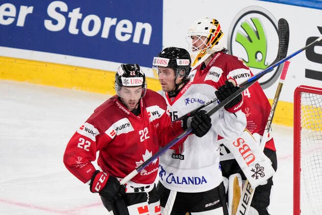 DAVOS, SWITZERLAND - DECEMBER 29: Mathias Brome of Örebro HK (C) fight for a position into the slot against Alan Quine of Team Canada (L) during the match between Orebro HK and Team Canada at Eisstadion Davos on December 28, 2022 in Davos, Switzerland. Davos Graubunden Switzerland Copyright: xJustPictures.ch JarixPestelaccix