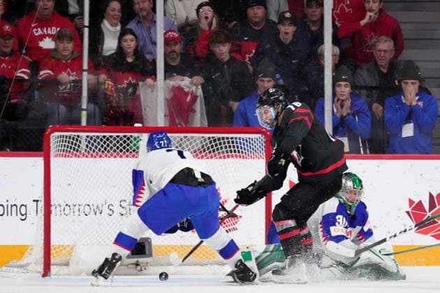 January 2, 2023, Halifax, NS, Canada: Canada s Connor Bedard, centre, scores the game-winning goal past Slovakia s goaltender Jan Korec, right, and Simon Nemec during overtime of IIHF World Junior Hockey Championship quarterfinal action in Halifax, Monday, Jan. 2, 2023. Connor Bedard, Jan Korec, Simon Nemec - ZUMAc35_ 20230102_zaf_c35_127 Copyright: xDarrenxCalabresex