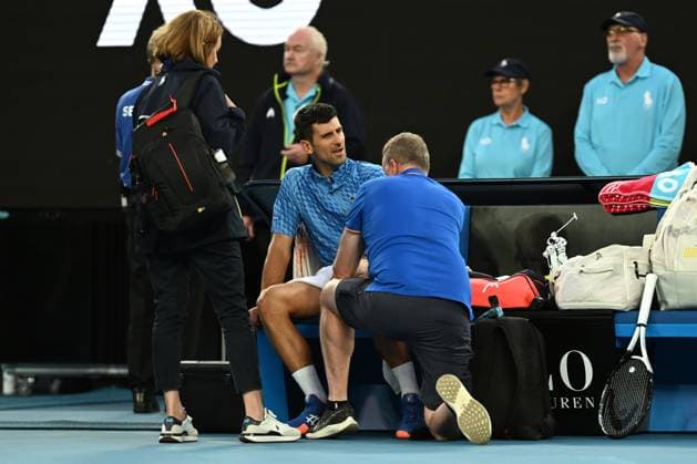 TENNIS AUSTRALIAN OPEN, Novak Djokovic of Serbia gets medical attention during his match against Grigor Dimitrov of Bulgaria during the 2023 Australian Open tennis tournament at Melbourne Park in Melbourne, Friday, January 1, 2021. ( NO ARCHIVING, EDITORIAL USE ONLY, NO USE IN BOOKS WITHOUT CONSENT MELBOURNE VICTORIA AUSTRALIA  Copyright: xLUKASxCOCHx 20230121001755028999