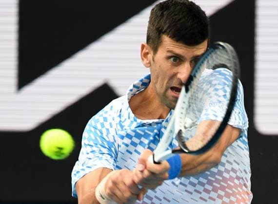 (230121) -- MELBOURNE, Jan. 21, 2023 -- Novak Djokovic of Serbia hits a return during the men s singles third round match against Grigor Dimitrov of Bulgaria at Australian Open tennis tournament in Melbourne, Australia, on Jan. 21, 2023. ) (SP)AUSTRALIA-MELBOURNE-TENNIS-AUSTRALIAN OPEN-DAY 6 GuoxLei 